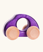 Bajo Beetle toy car in Violet purple, a wooden push-along toy for toddlers with a circular hand hole and natural wood wheels, available online from Babipur.