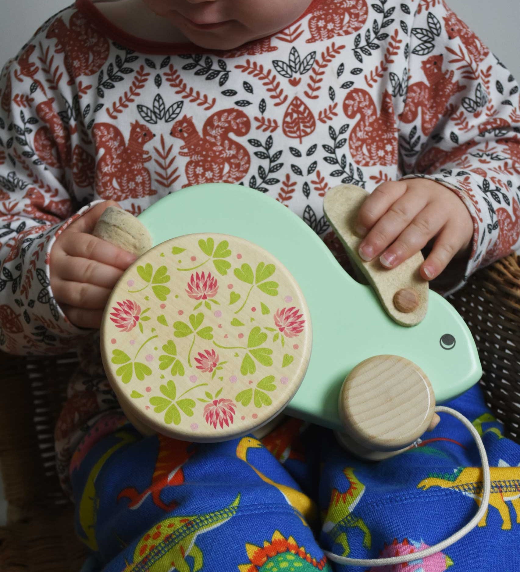A close up of a child holding the mint coloured big Bajo rabbit toy on their lap. These heirloom quality toys by Bajo are part of a wide range of wooden toys available here at Babipur.