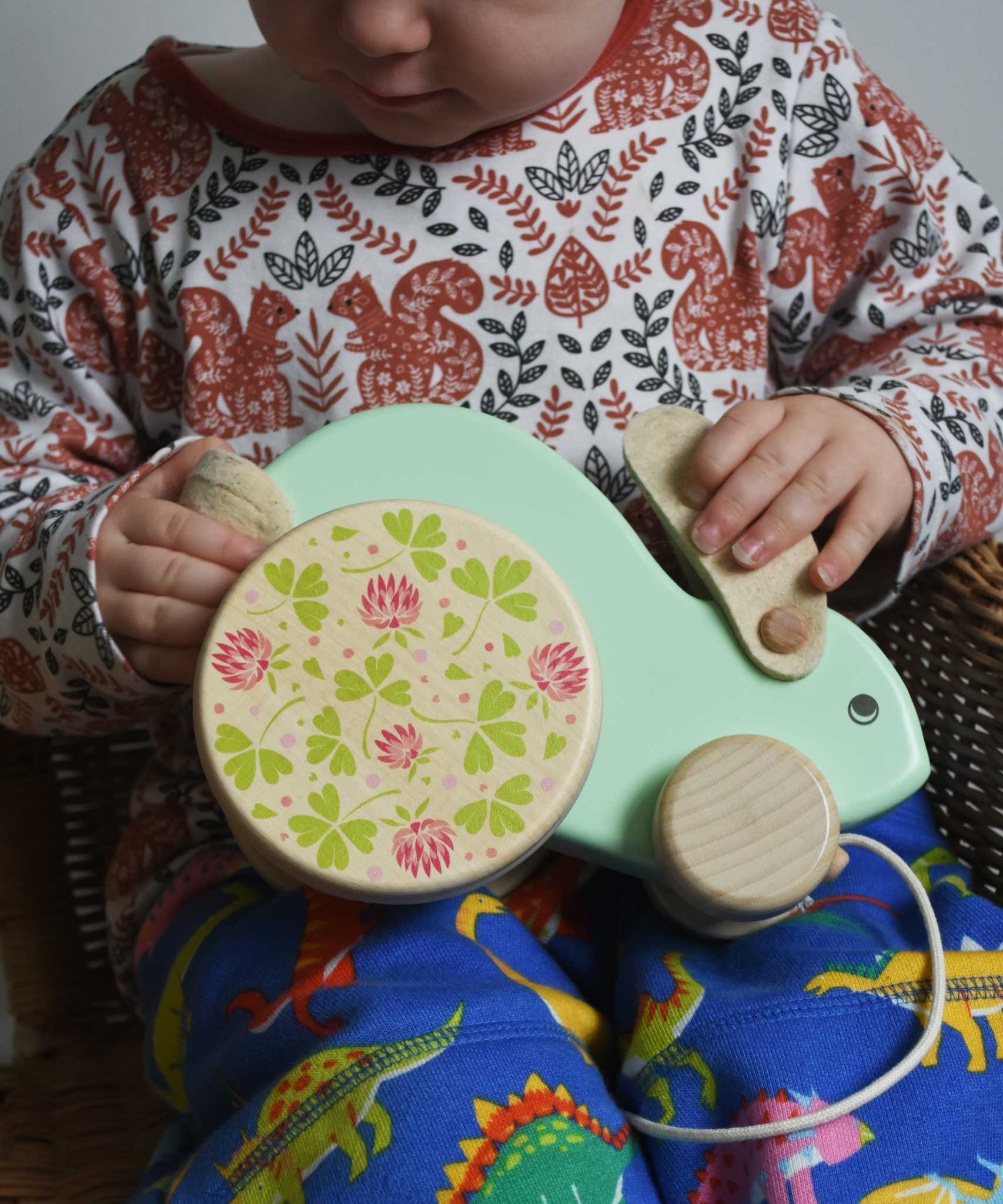 A close up of a child holding the mint coloured big Bajo rabbit toy on their lap. These heirloom quality toys by Bajo are part of a wide range of wooden toys available here at Babipur.