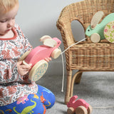 A child holding the pink coloured Bajo big rabbit. The mint and small pink rabbits can be seen in the background. These heirloom quality toys by Bajo are part of a wide range of wooden toys available here at Babipur.