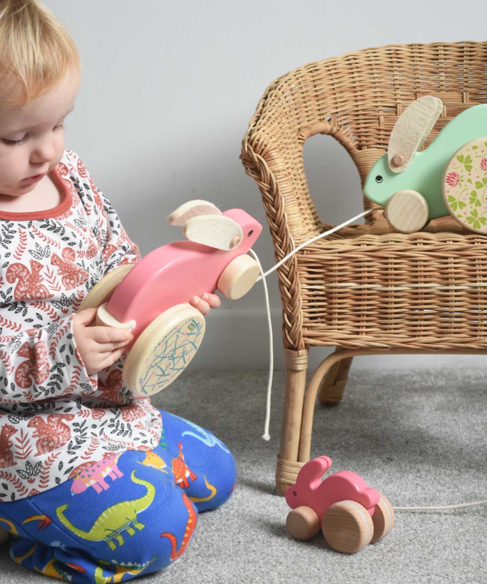 A child holding the pink coloured Bajo big rabbit. The mint and small pink rabbits can be seen in the background. These heirloom quality toys by Bajo are part of a wide range of wooden toys available here at Babipur.