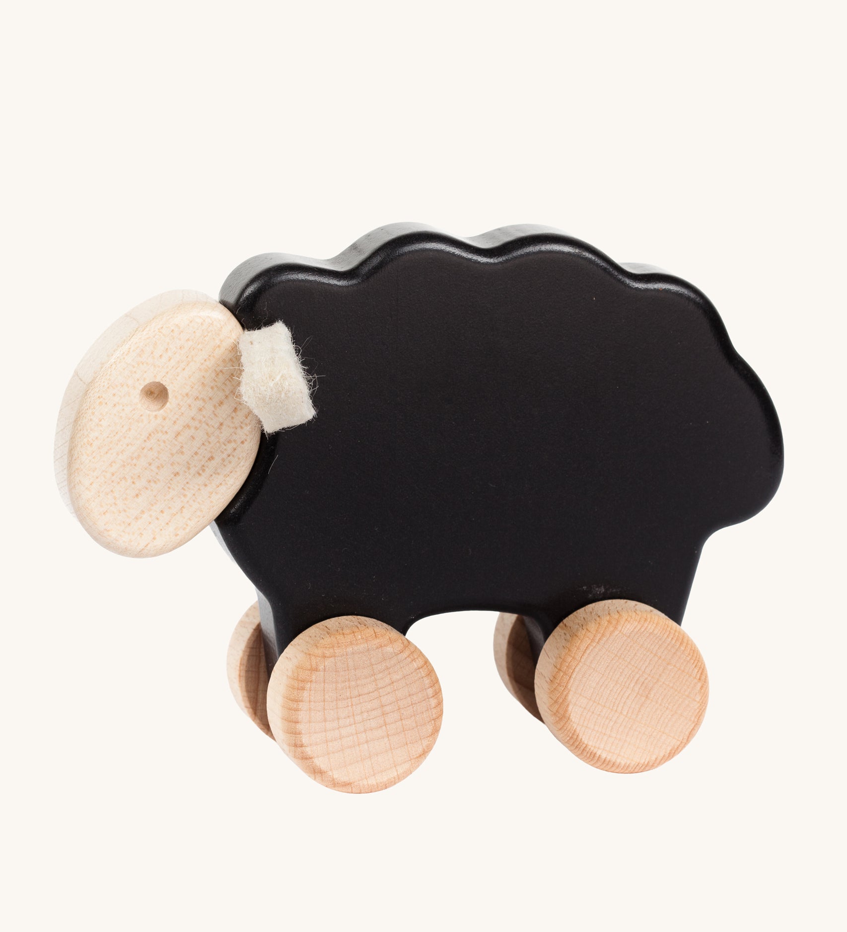 Bajo black wooden sheep toy. This pull along sheep figure has a black coloured body, natural wooden wheels and head and white felt ear details. These heirloom quality toys by Bajo are part of a wide range of wooden toys available here at Babipur. 