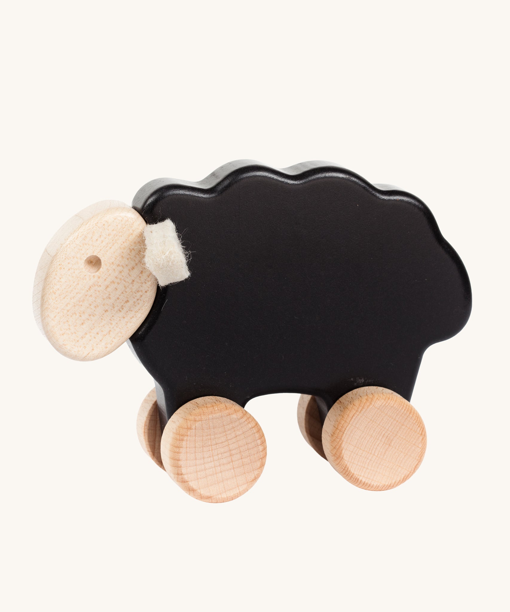 Bajo black wooden sheep toy. This pull along sheep figure has a black coloured body, natural wooden wheels and head and white felt ear details. These heirloom quality toys by Bajo are part of a wide range of wooden toys available here at Babipur. 