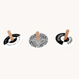 Bajo black and white Spinning Tops. Wooden spinning tops with Black and white monochrome designs with natural wooden sticks.
