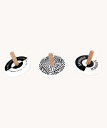 Bajo black and white Spinning Tops. Wooden spinning tops with Black and white monochrome designs with natural wooden sticks.