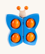 Bajo Blue Butterfly Teether wooden toy. A blue coloured butterfly with orange balls. These heirloom quality toys by Bajo are part of a wide range of wooden toys available here at Babipur. 