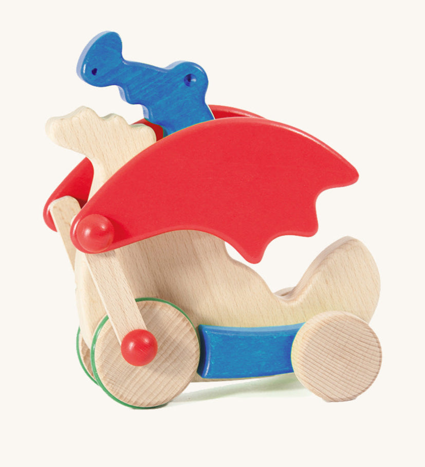 Bajo blue pull along dragon wooden toy available at Babipur. Features two wheels at the front and back and red wing that move along with the front wheels