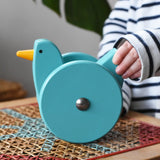 Child playing with the Bajo blue wobbling chicken push along toy.