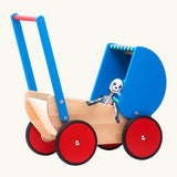 Bajo wooden dolls pram and walker with blue hood and handle. A soft toy has been placed inside the toy pram.