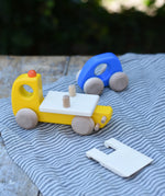 Bajo yellow breakdown lorry wooden toy with a blue coloured car. The ramp is shown taken off the trailer. 