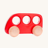 A Bajo red coloured wooden push along bus toy. This bus is part of a wide range of Bajo wooden toy vehicles available at Babipur.