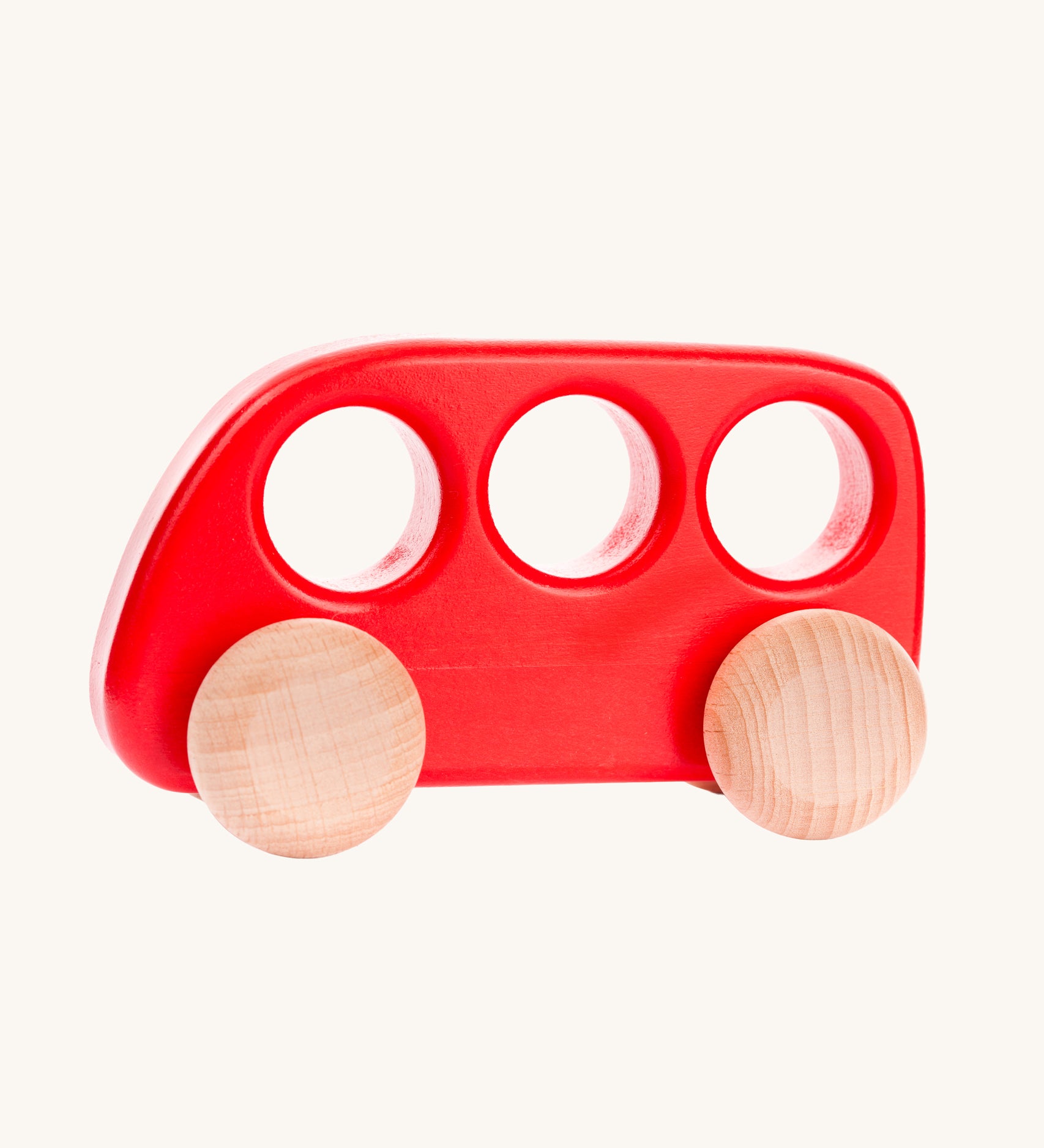 A Bajo red coloured wooden push along bus toy. This bus is part of a wide range of Bajo wooden toy vehicles available at Babipur.