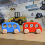 A blue and red wooden Bajo bus placed on a Triclimb Miri slide. These heirloom quality toys by Bajo are part of a wide range of wooden toys available here at Babipur. 
