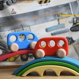 A blue and red Bajo wooden push along bus toy placed on pieces of the Gluckskafer bridge. These heirloom quality toys by Bajo are part of a wide range of wooden toys available here at Babipur. 