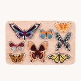 Bajo World Of Butterflies Sorter Puzzle. This puzzle has butterfly shaped pieces that are decorated on both sides that slot into the coordinating shapes on the base. These heirloom quality toys by Bajo are part of a wide range of wooden toys available here at Babipur.