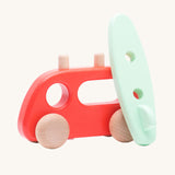 Bajo Camper Van With Surf Board wooden toy vehicle. This red camper van toy comes with a green coloured surf board that sits on the roof. 
These heirloom quality toys by Bajo are part of a wide range of wooden toys available here at Babipur. 