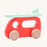 Bajo Camper Van With Surf Board wooden toy vehicle. This red camper van toy comes with a green coloured surf board that sits on the roof. 
These heirloom quality toys by Bajo are part of a wide range of wooden toys available here at Babipur. 