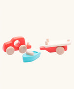 Bajo toys wooden car with boat and trailer. A coral red vehicle and trailer with a blue boat. All pieces have been taken apart.