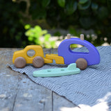 Bajo yellow car and purple camper wooden toy vehicle with the mint green surfboard taken off the roof rack.