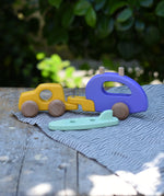 Bajo yellow car and purple camper wooden toy vehicle with the mint green surfboard taken off the roof rack.