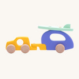 Bajo Car and Camper wooden toy. The toy comes with is a yellow car, purple camper trailer attachment and a mint green coloured surf board that sits on the roof of the camper.These heirloom quality toys are part of a wide range of Bajo wooden toys available here at Babipur.