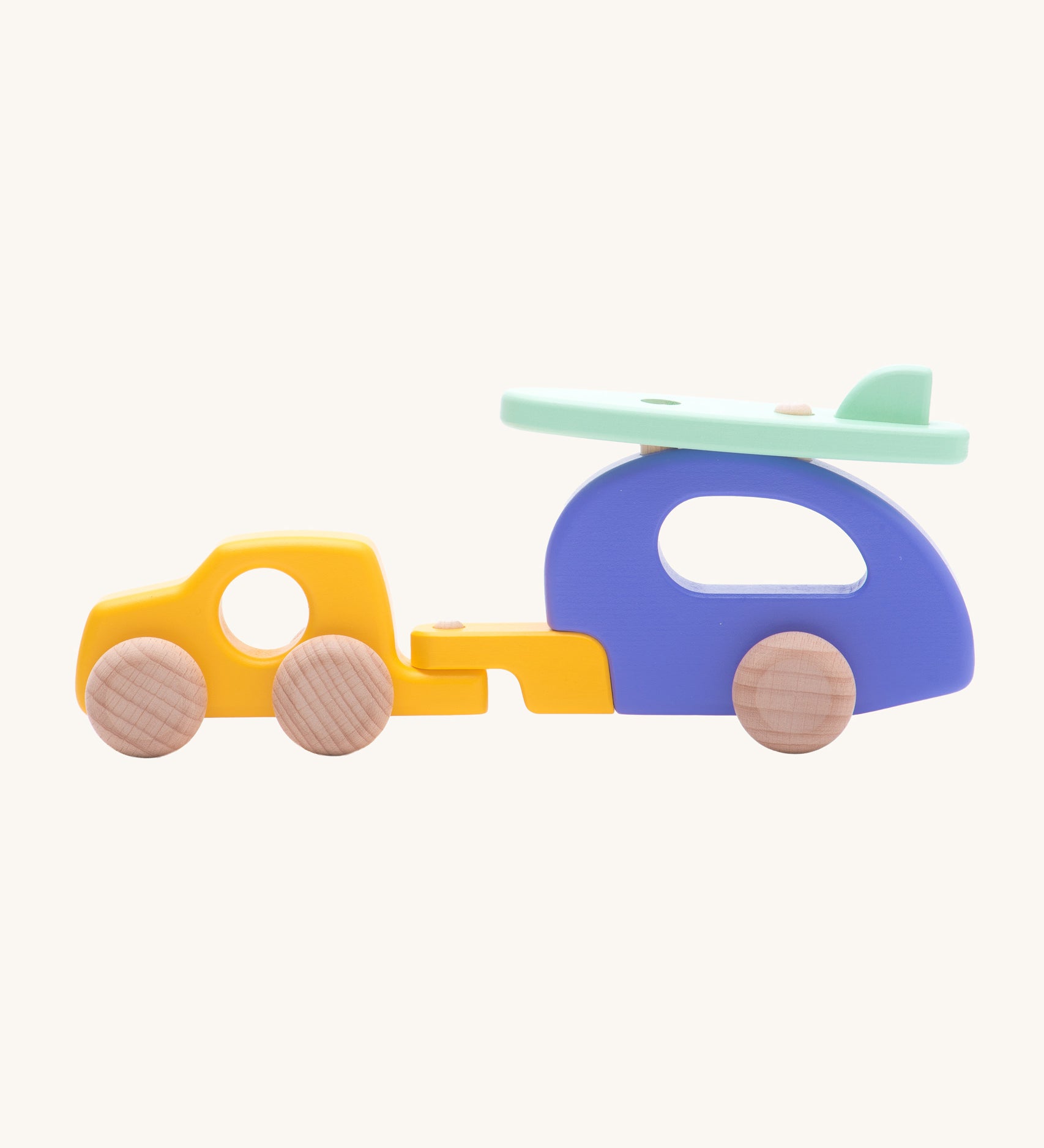 Bajo Car and Camper wooden toy. The toy comes with is a yellow car, purple camper trailer attachment and a mint green coloured surf board that sits on the roof of the camper.These heirloom quality toys are part of a wide range of Bajo wooden toys available here at Babipur.