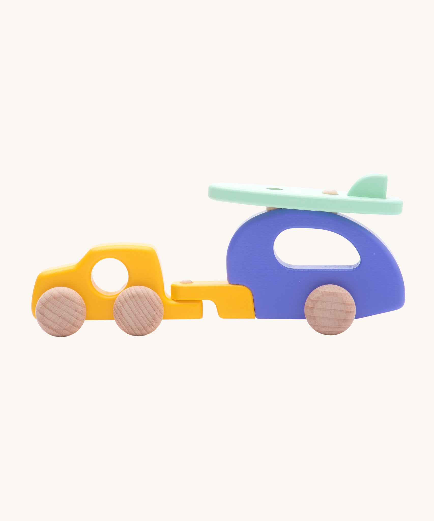 Bajo Car and Camper wooden toy. The toy comes with is a yellow car, purple camper trailer attachment and a mint green coloured surf board that sits on the roof of the camper.These heirloom quality toys are part of a wide range of Bajo wooden toys available here at Babipur.