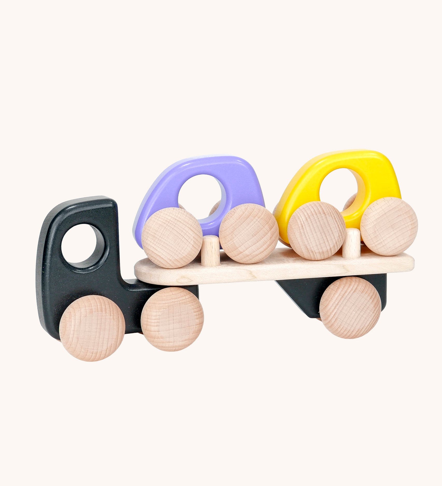 A black coloured Bajo wooden toy car transporter available at Babipur. This black coloured truck has natural wooden wheels and comes with two mini cars, one purple and one yellow.