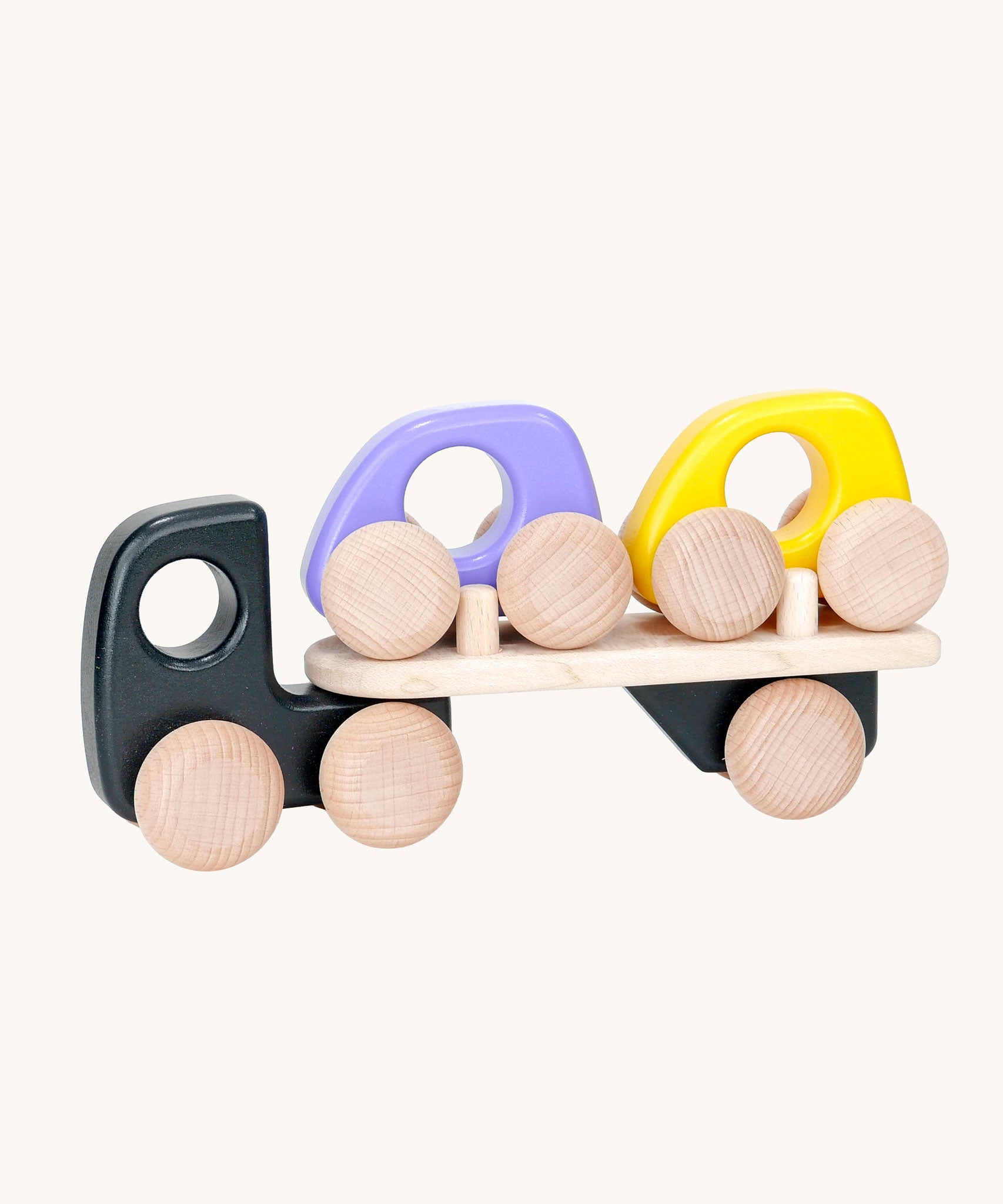 A black coloured Bajo wooden toy car transporter available at Babipur. This black coloured truck has natural wooden wheels and comes with two mini cars, one purple and one yellow.