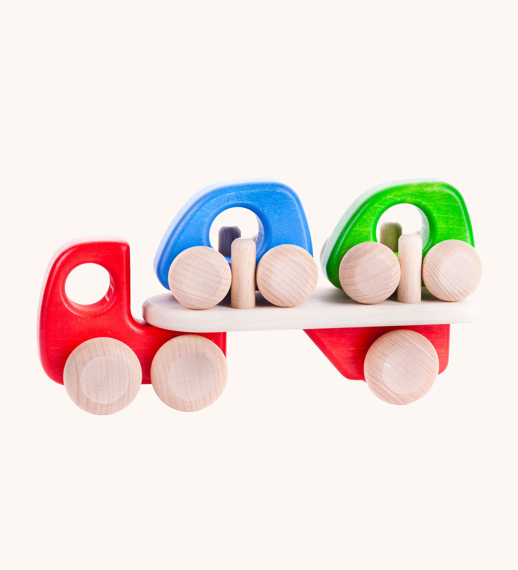 A red coloured Bajo wooden toy car transporter available at Babipur. This red coloured truck has natural wooden wheels and comes with two mini cars, one blue and one green.