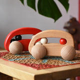 Bajo wooden toy cars with beads push along toys placed on a rattan stool in the Babipur playroom.