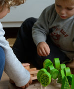 Children playing with the different trees from Bajo's forest central park set
