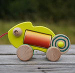 wooden bajo chameleon toy on a wooden surface