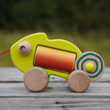 wooden bajo chameleon toy on a wooden surface