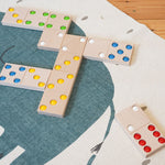 Bajo children's XXL wooden dominos game laid out on a blue and white carpet