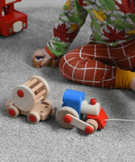 A child playing with the Bajo choo-choo train wooden pull-along toy. These heirloom quality toys by Bajo are part of a wide range of wooden toys available here at Babipur.