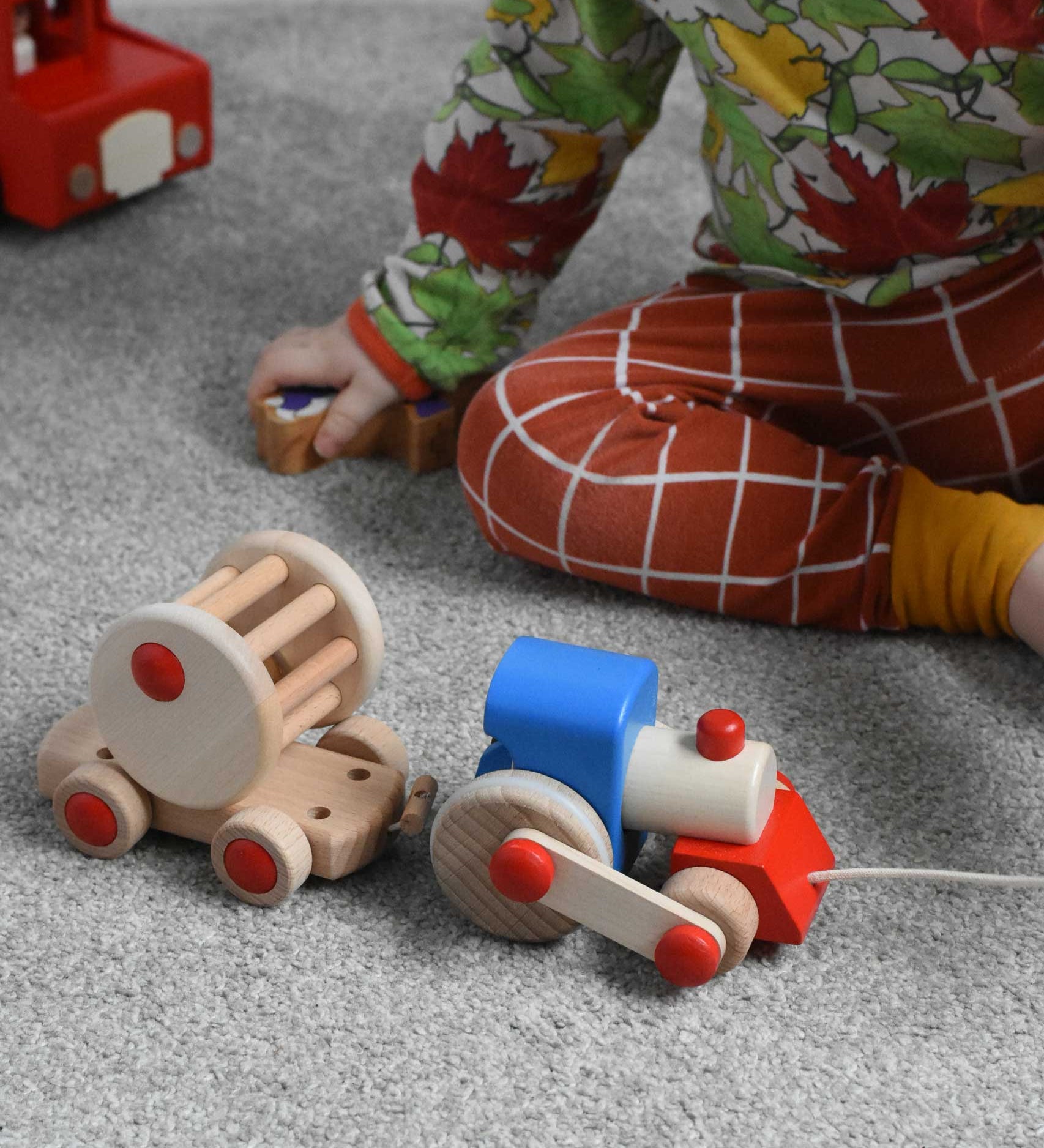A child playing with the Bajo choo-choo train wooden pull-along toy. These heirloom quality toys by Bajo are part of a wide range of wooden toys available here at Babipur.