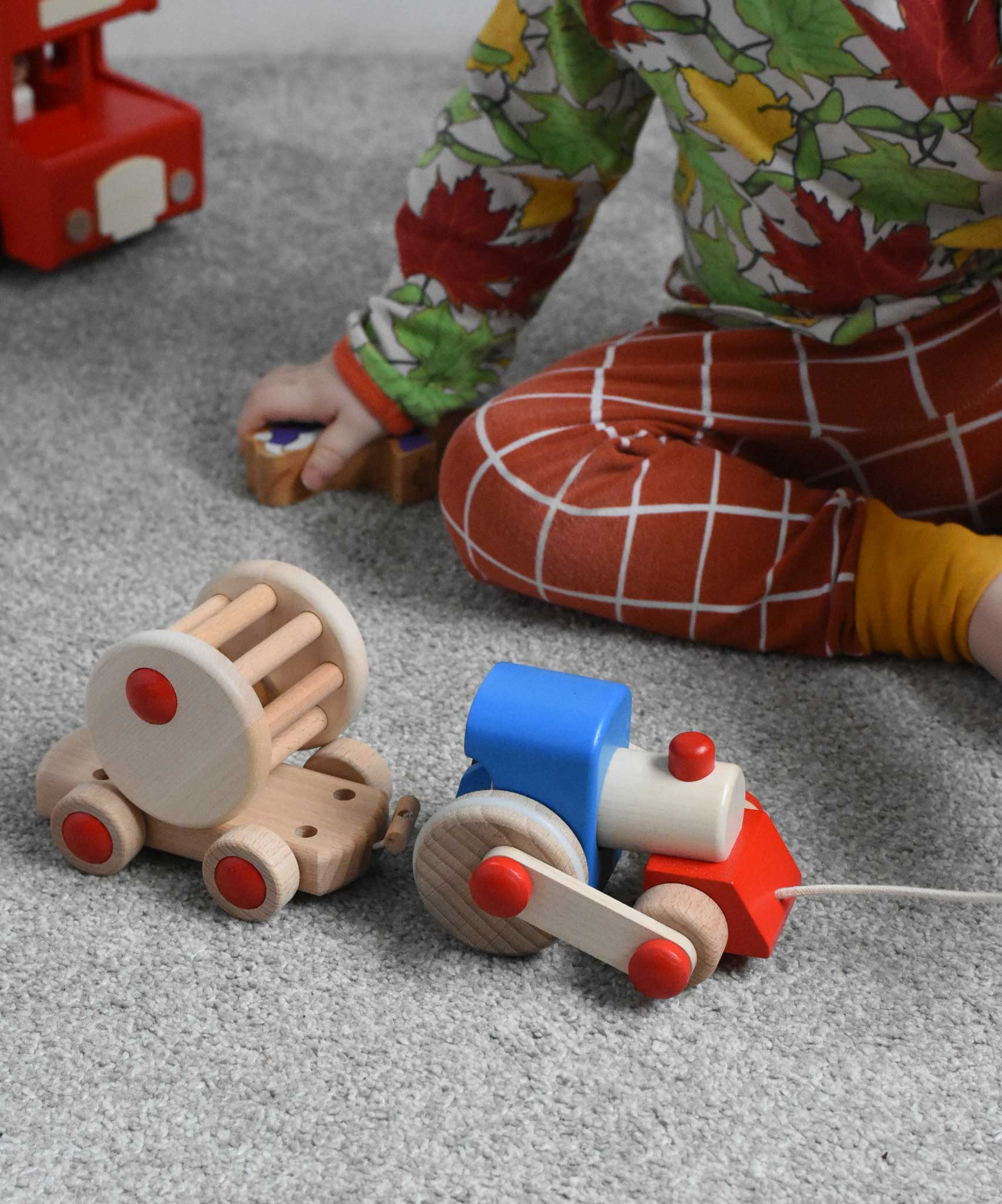 A child playing with the Bajo choo-choo train wooden pull-along toy. These heirloom quality toys by Bajo are part of a wide range of wooden toys available here at Babipur.