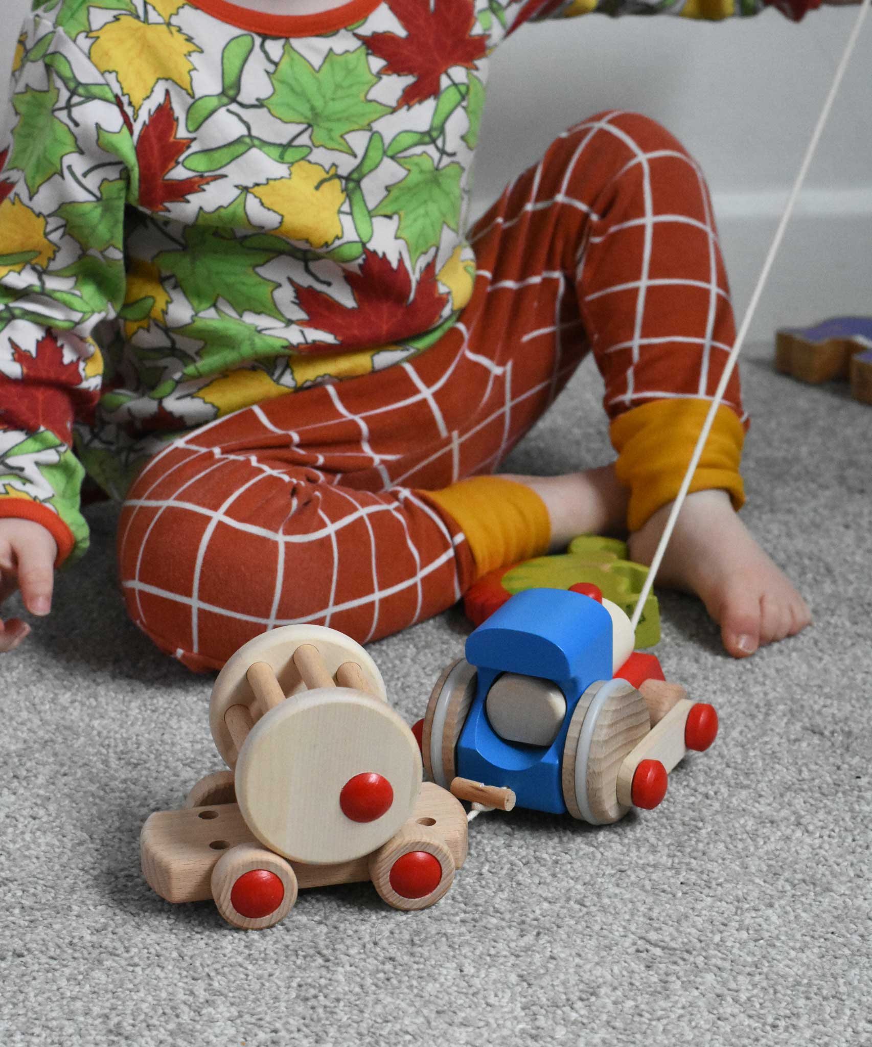 A child playing with the Bajo choo-choo train wooden pull-along toy. These heirloom quality toys by Bajo are part of a wide range of wooden toys available here at Babipur.