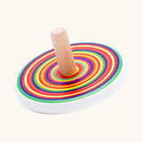 Bajo colourful circles spinning top wooden toy. White painted wooden base with a rainbow stripe decorated top and a natural wood handle.
