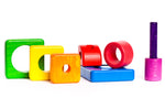 Pieces of the Bajo plastic-free wooden shape stacking toy laid out on a white background