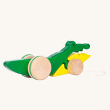 Bajo Pull Along Crocodile wooden toy.  A green and yellow crocodile on natural wooden wheels with a string attached to the front.
These heirloom quality toys by Bajo are part of a wide range of wooden toys available here at Babipur. 