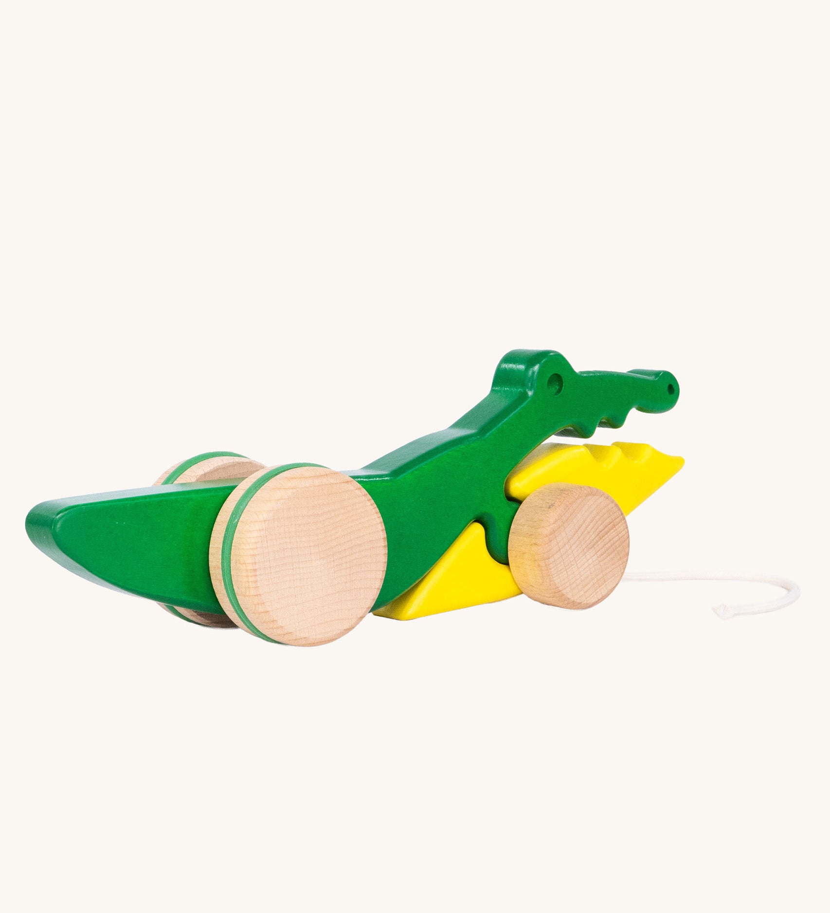 Bajo Pull Along Crocodile wooden toy.  A green and yellow crocodile on natural wooden wheels with a string attached to the front.
These heirloom quality toys by Bajo are part of a wide range of wooden toys available here at Babipur. 