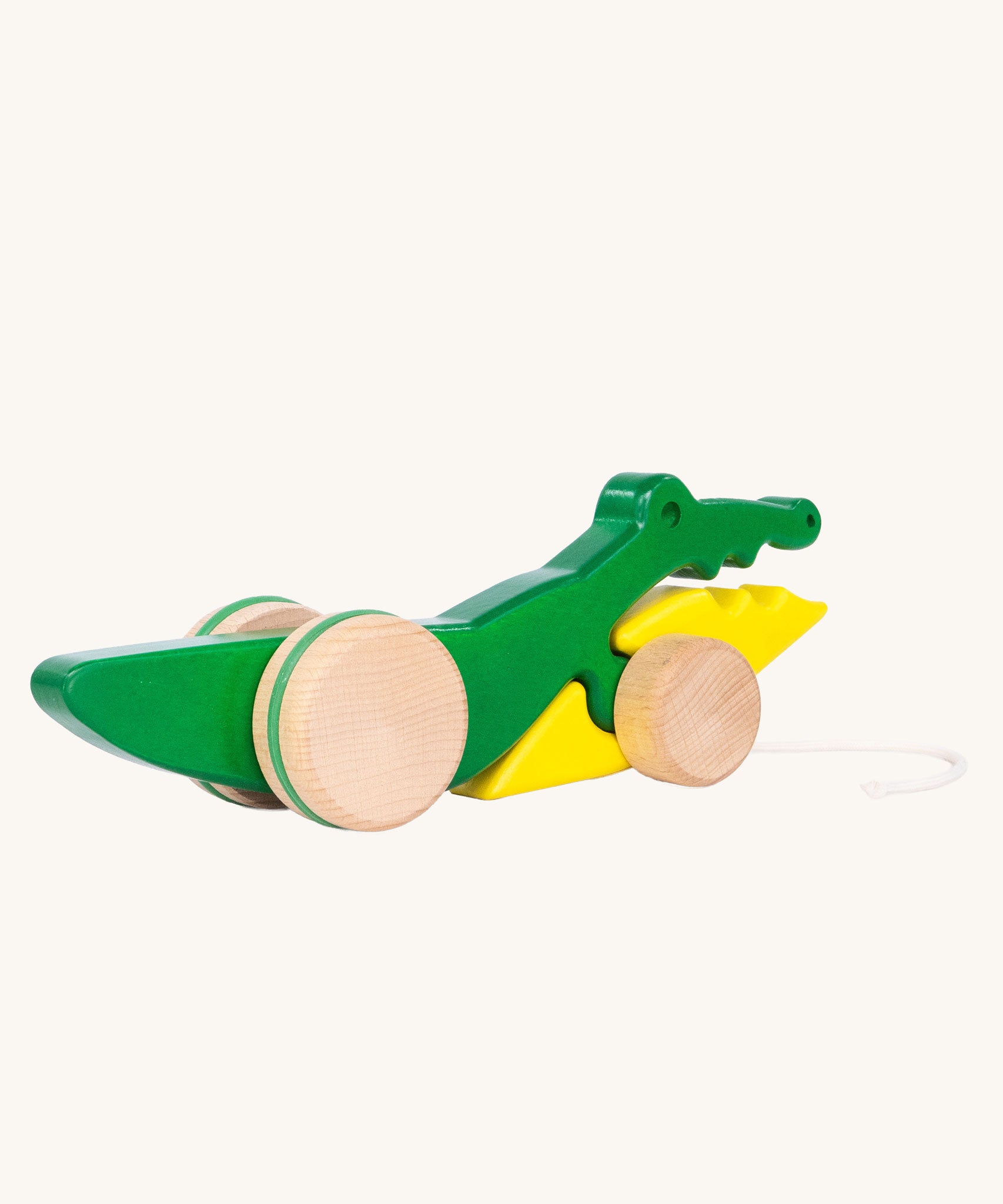 Bajo Pull Along Crocodile wooden toy.  A green and yellow crocodile on natural wooden wheels with a string attached to the front.
These heirloom quality toys by Bajo are part of a wide range of wooden toys available here at Babipur. 