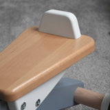 A close up of the white coloured back on the seat of the Bajo Toys wooden Cycle toddler Ride-On in the monochrome, white and grey colourway. The wooden ride on cycle is part of a wode range of wooden toys available here at Babipur. 