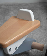 A close up of the white coloured back on the seat of the Bajo Toys wooden Cycle toddler Ride-On in the monochrome, white and grey colourway. The wooden ride on cycle is part of a wode range of wooden toys available here at Babipur. 