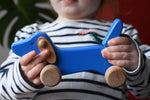Bajo blue dachshund puppy in a child's hands in the Babipur playroom. 
