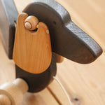 Close up of the floppy wooden ears on the Bajo dark oak pull along toy dog