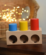 The Bajo Deep And Shallow Sorter wooden toy placed on a small wooden table. These heirloom quality toys by Bajo are part of a wide range of wooden toys available here at Babipur. 