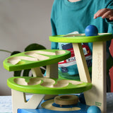 Child playing with the Bajo Dewdrop, Coloured wooden ball run.